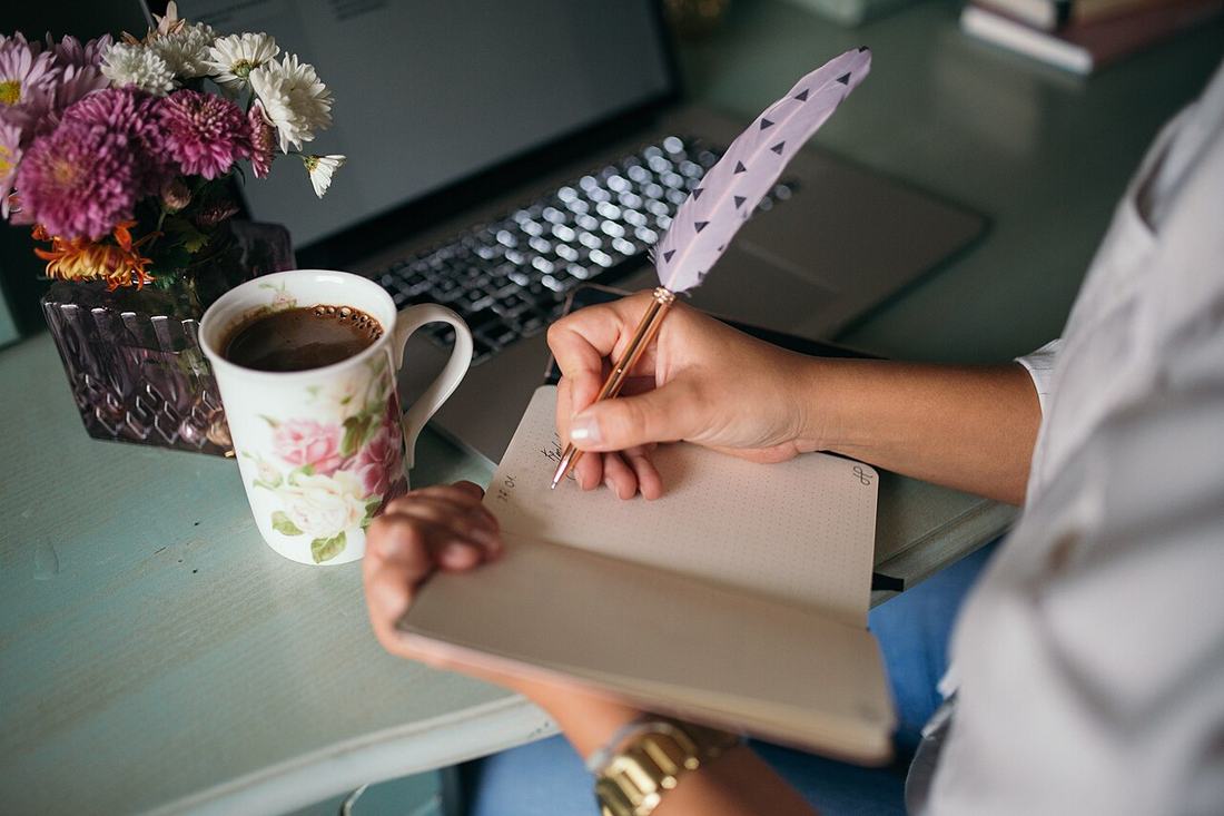 Writing in a notebook at a desk